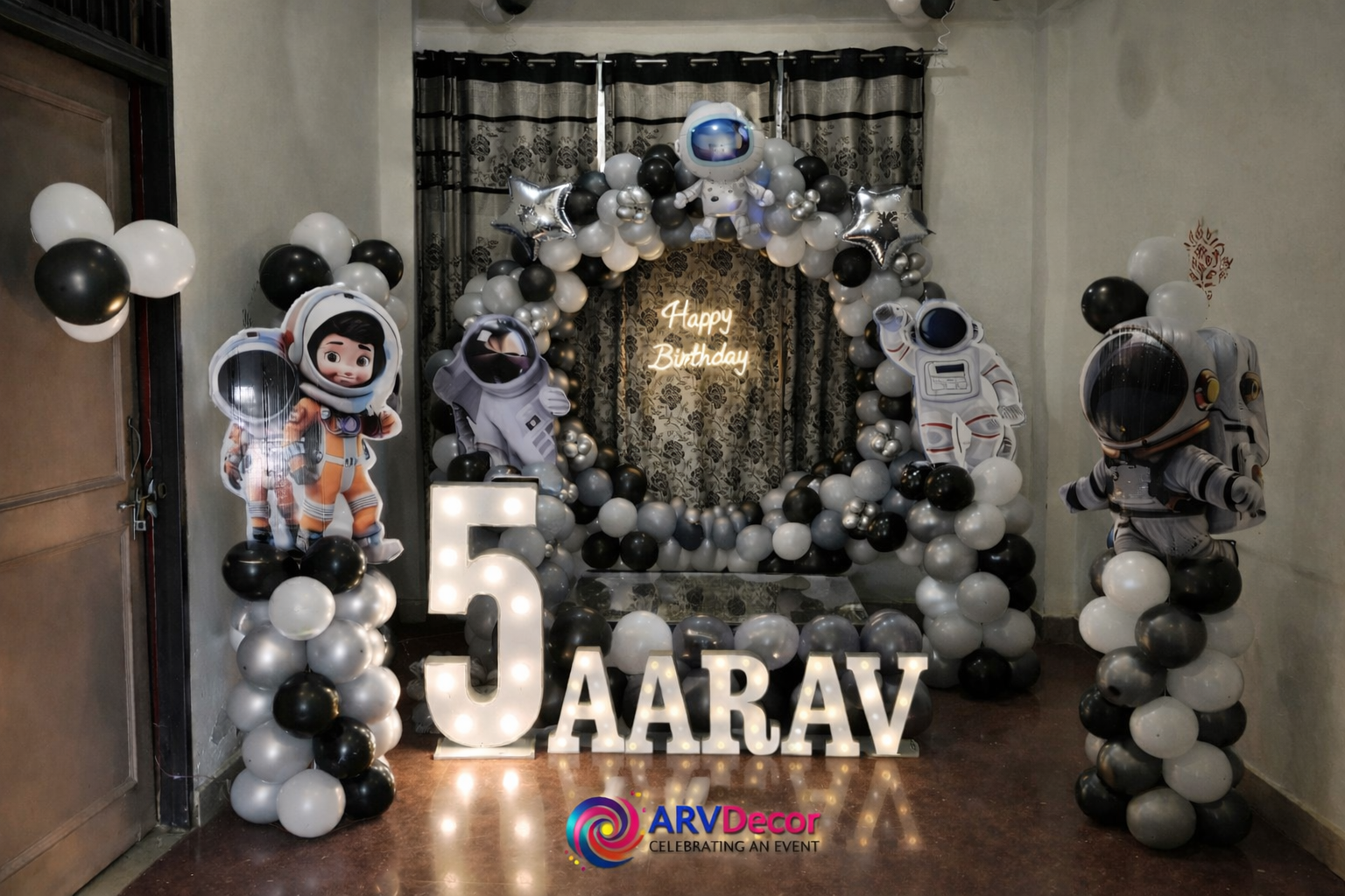 Space Astronaut Kids Birthday Decor with Black and Silver Balloon Arch and Name Lights