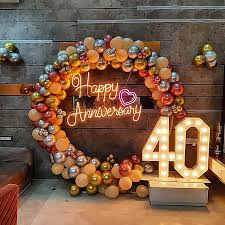 Modern Gold and Silver 40th Anniversary Decor with Balloon Ring and Neon Sign