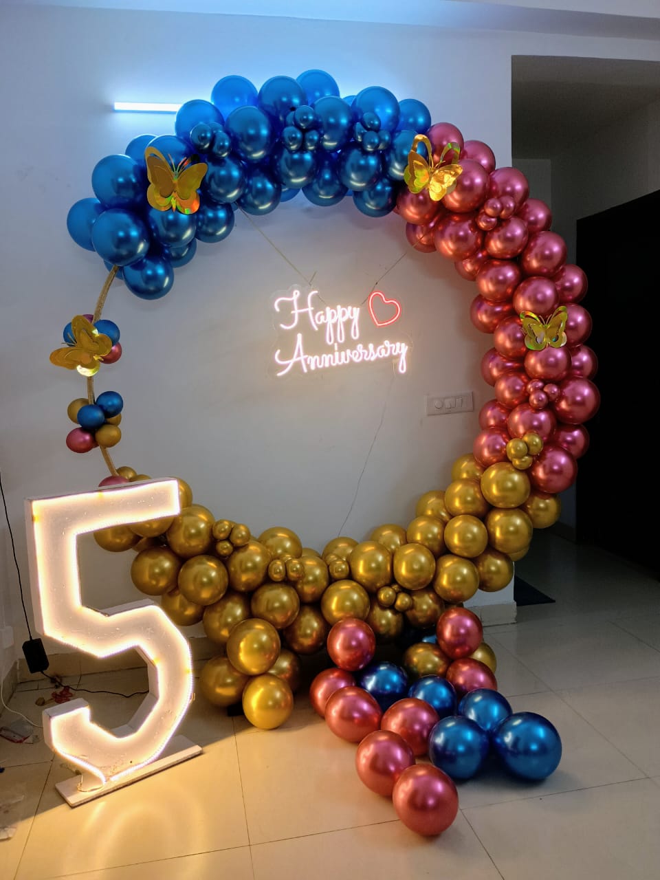 Modern 5th Anniversary Decor with Blue, Gold & Rose Gold Balloon Arch and Neon Sign