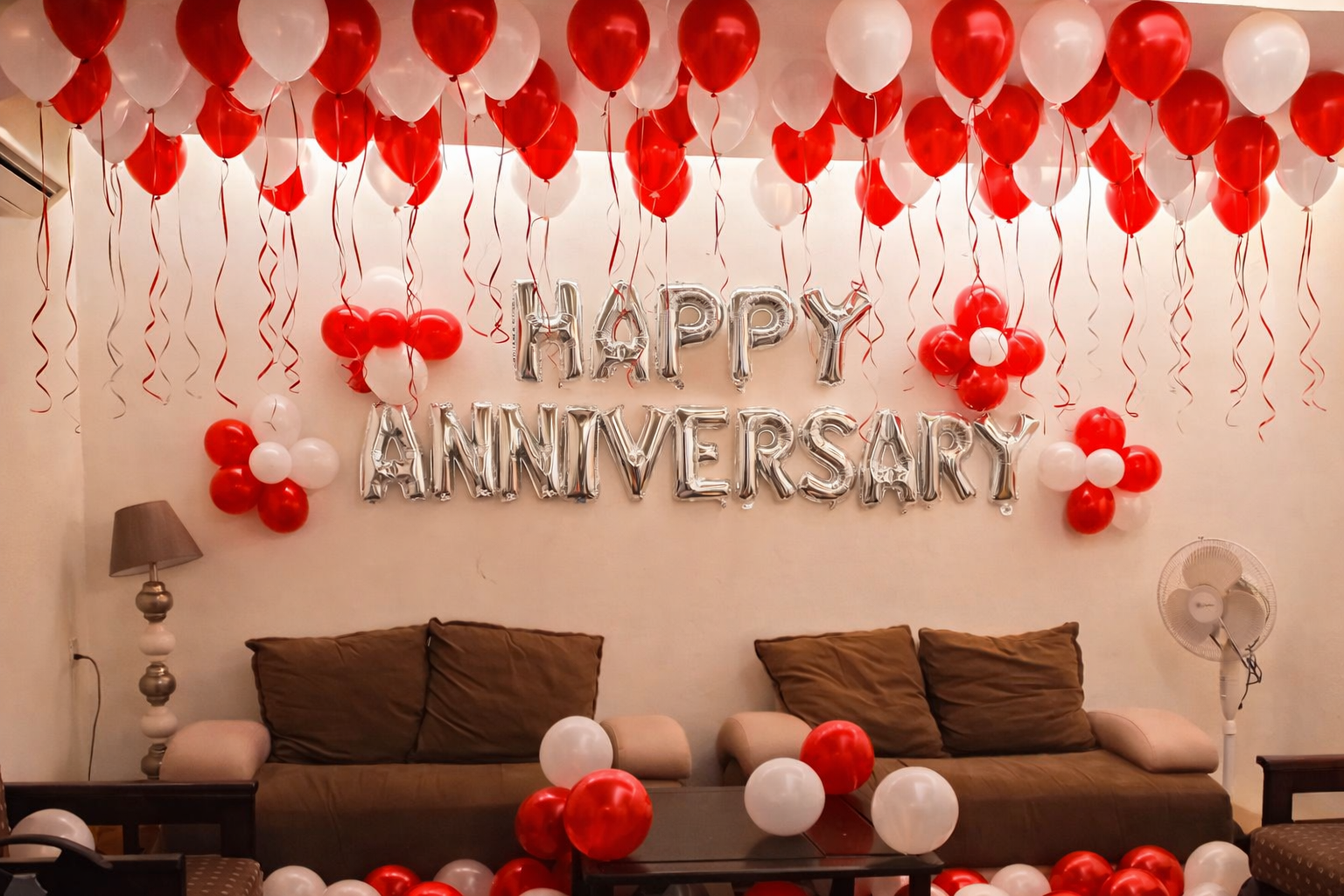 Red And White Anniversary Decor With Balloon Ceiling And Silver Letter Balloons