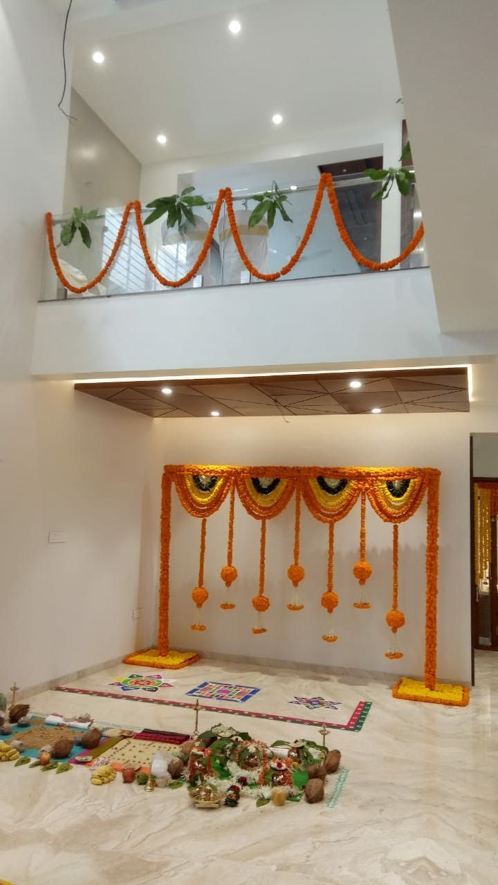 Traditional Marigold Floral Backdrop And Rangoli Decor For Home Pooja Ceremony