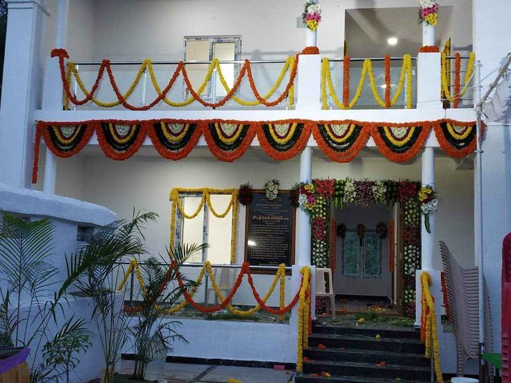 Traditional Housewarming Floral Decor With Orange And Yellow Garlands