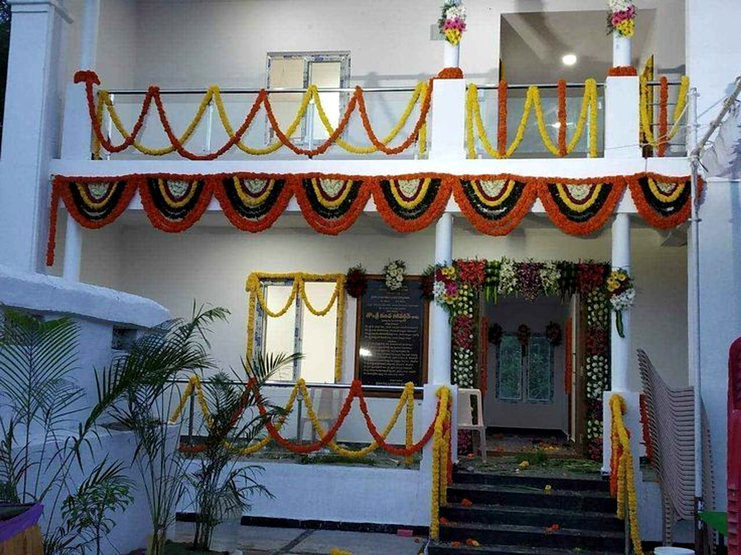 Traditional Housewarming Floral Decor With Orange And Yellow Garlands - Housewarming by ARV Decor thumbnail 2